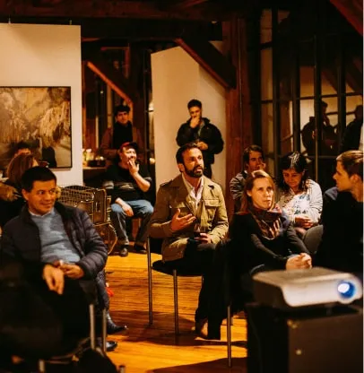 a group of people sitting in chairs in a room